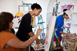 非裔美国女学生在教室的画架上画画